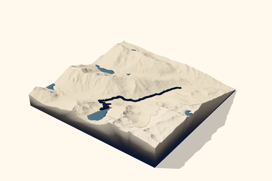 Digital design preview of a Colchuck Lake trail relief: ivory mountain terrain, steel-blue lakes and a raised ink trail.
